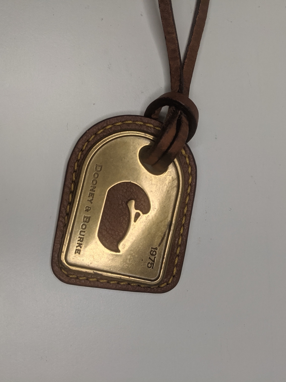 Dooney & Bourke Brown Leather Luggage Tag with Gold Accent